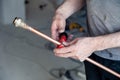 Closeup worker plumber master measures copper pipes with roulette tape, cut pipe with cutter. Concept installation, changing