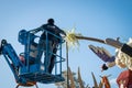 Closeup of worker preparing Rose Parade Float