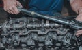 Closeup of a worker repairing an internal combustion engine Royalty Free Stock Photo