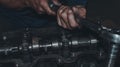 Closeup of a worker repairing an internal combustion engine Royalty Free Stock Photo