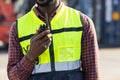 Closeup worker using ham radio for operation control in cargo port shipping Royalty Free Stock Photo