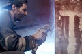 Closeup of a worker who processes granite using a grinding machine. Royalty Free Stock Photo