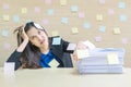 Closeup working woman are boring from pile of hard work and work paper in front of her in work concept on blurred wooden desk and Royalty Free Stock Photo