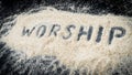 Closeup of WORSHIP text written on white sand Royalty Free Stock Photo