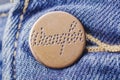 Closeup of Wrangler button on blue jeans.