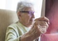 Closeup wrinkled hand of a senior person reading newspaper