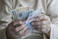 Closeup of wrinkled hands counting turkish lira banknotes Royalty Free Stock Photo