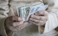 Closeup of wrinkled hands counting turkish lira banknotes Royalty Free Stock Photo