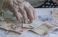 Closeup of wrinkled hands counting turkish lira banknotes Royalty Free Stock Photo