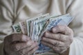 Closeup of wrinkled hands counting turkish lira banknotes Royalty Free Stock Photo