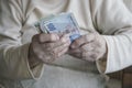 Closeup of wrinkled hands holding turkish lira banknotes Royalty Free Stock Photo