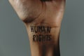 The text human rights in the wrist of a man