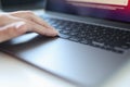 Closeup of writer hand writing on laptop on desk at home or office Royalty Free Stock Photo