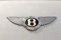 Closeup of a "Bentley" emblem on a white car