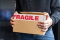 Closeup of a "Fragile" cardboard box with a man holding it Royalty Free Stock Photo