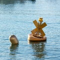 Closeup of x-shaped and ordinary buoys on the water surface