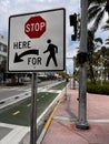Closeup of 'stop here' pedestrian sign in street