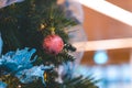 Closeup of Xmas baubles hanging on Christmas tree for Christmas and New Year decoration. Background for winter celebrations with Royalty Free Stock Photo