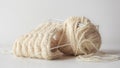 Closeup of a yarn of beige thread on  a white background Royalty Free Stock Photo