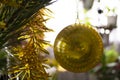 Closeup of yellow bauble hanging from a decorated Christmas tree. Retro filter effect. Royalty Free Stock Photo