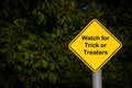 Closeup - Yellow Blank Sign against dark green foliage - Reads Watch for Trick or Treaters Royalty Free Stock Photo
