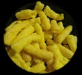 Closeup of yellow chips, potato fries background with black vignettes frame, food photography