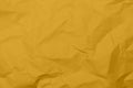Closeup yellow crumpled paper texture background Yellow wrinkled fabric texture background