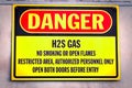 Closeup of a yellow Danger H2S Gas sign