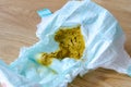 Closeup of yellow dirty stinky diaper of new born baby lying on