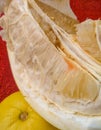 Closeup Yellow fresh pomelo and it`s pieces on red fabric background