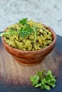 closeup the yellow fried rice with black month,brown ginger,green radish leaves in the wooden bowl soft focus natural grey brown