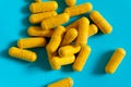 Closeup of yellow harmaceutical medicine pills or vitamins in capsules Royalty Free Stock Photo