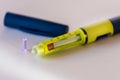 Closeup of a yellow insulin injector of disposable type