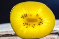 Closeup of yellow kiwi slice on wood Royalty Free Stock Photo