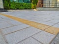 Closeup of a yellow line delimiting a parking spot on the cement floor, Sao Paulo, Brazil. Royalty Free Stock Photo