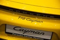 Closeup of a yellow Porsche Cayman car under the bright light