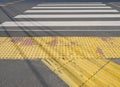 Closeup of a yellow road surface made for blind people