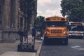 Closeup of a  yellow school bus parked in front of a brick building Royalty Free Stock Photo