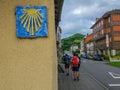 Closeup of a yellow shell of Camino de Santiago with pilgrims wa