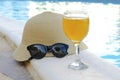 Closeup of yellow straw hat and black protective sunglasses, goggles, fresh orange juice smoothie drink cocktail on