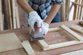 Closeup young asian carpenter polishing wooden job with sanding machine Royalty Free Stock Photo