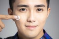 Closeup young man applying facial cream Royalty Free Stock Photo