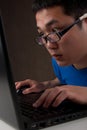 Closeup of young asian man working on laptop Royalty Free Stock Photo