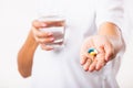 Woman hold pill drugs in hand ready take medicines with a glass of water