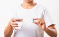 Woman hold pill drugs in hand ready take medicines with a glass of water