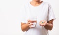 Woman hold pill drugs in hand ready take medicines with a glass of water