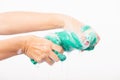 Female squeeze wring out wet fabric cloth with detergent have soapy bubble in water