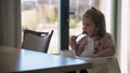 Closeup of young baby in white feeding high chair, kid is trying to eat himself, happy child with food stained face Royalty Free Stock Photo