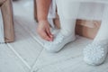 Closeup of young ballerina legs, sit in pointe shoes with snowflake decor at white wooden floor background. Ballet Royalty Free Stock Photo