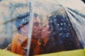 Closeup of young beautiful couple kissing under umbrella Royalty Free Stock Photo